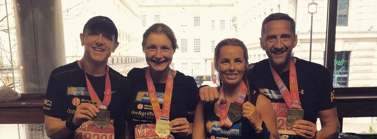 Steve Jones (Partner), Wendy Worger (Marketing Manager), Victoria Anderson (Social Media Executive) and Simon Trippett (Director) at The Property Centre with their winners medals after completing the London Marathon for charity.